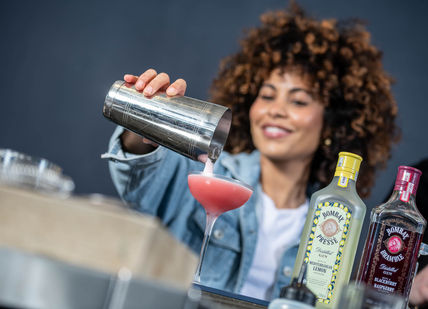 An image of a woman making a drink, Gin Masterclass with a guided tour. Bombay Sapphire Distillery