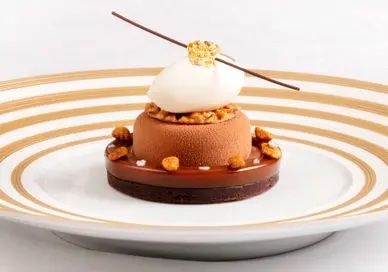 A chocolate dessert on a white plate.