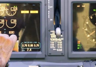 A man is pointing at the controls of a plane.