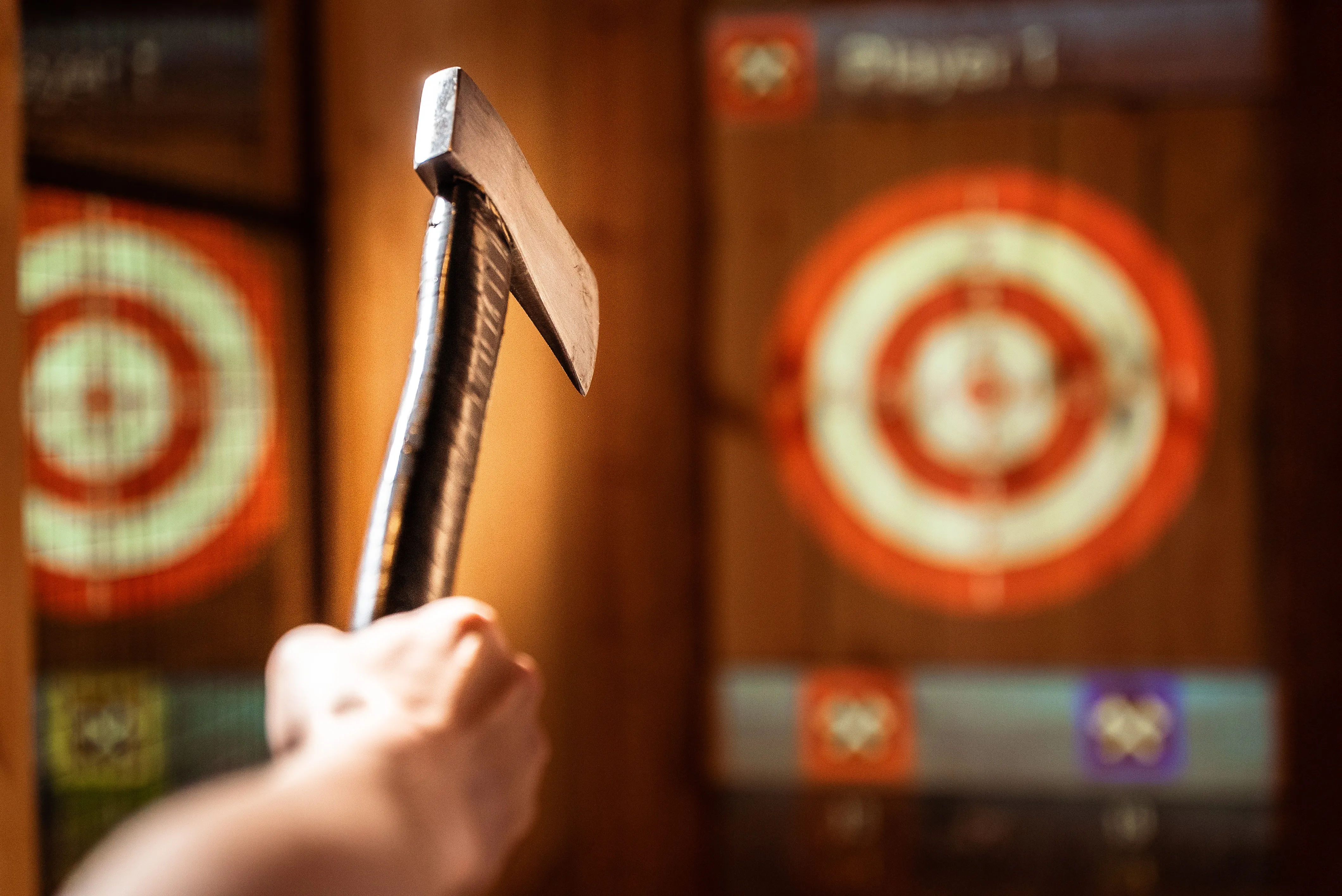 A person holding an axe in front of a target.