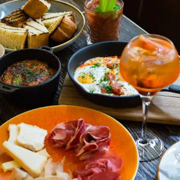 A table full of food and drinks on a wooden table