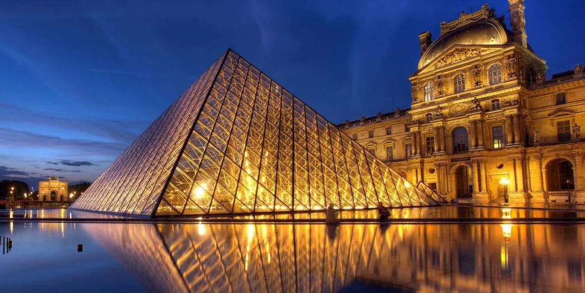 The pyramid of the Louvre at night.