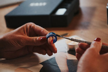 A woman is putting a ring on her finger.