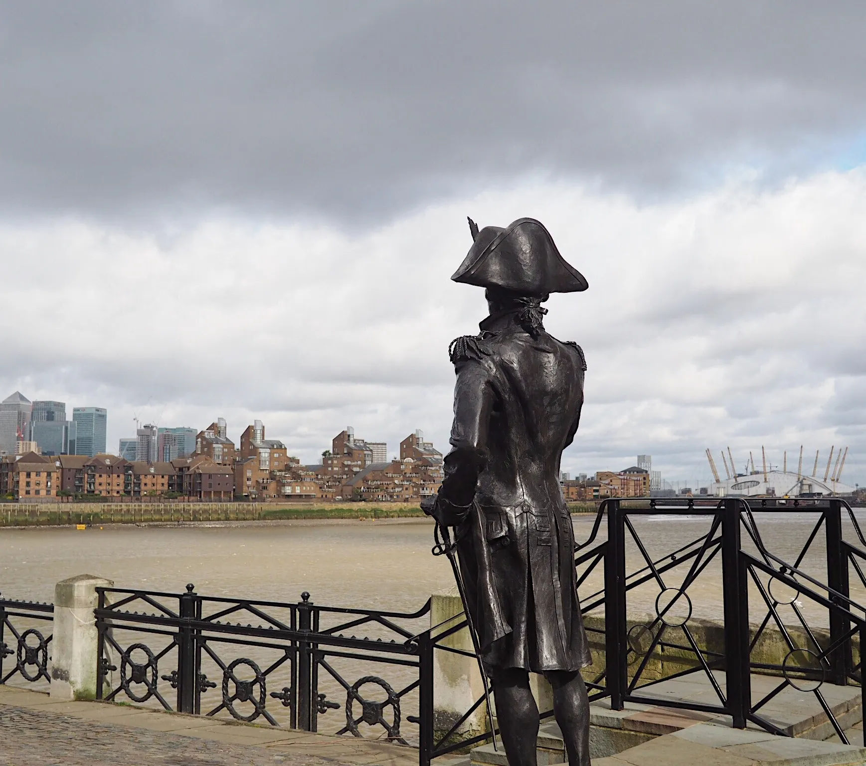 A statue of a man looking out over a city