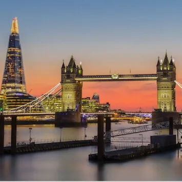 The Shard and tower bridge in London at sunset.