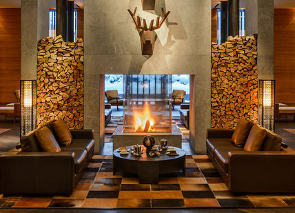 An image of a living room with a fireplace, Spa package. The Chedi Andermatt