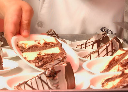 An image of a person putting a piece of cake, Intensive Professional Pastry Programme. Chef Academy London