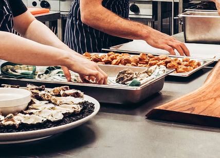 An image of a chef preparing food in a kitchen, Professional Chef Course. Chef Academy London