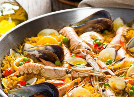 An image of a bowl of seafood and rice, Cooking Class to Host A Dinner Party. The Chef and The Dish