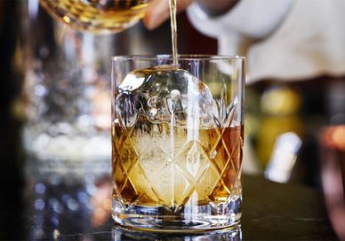 An image of a person pouring a drink, Rum Experience. Chesterfield Mayfair Hotel