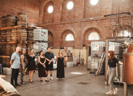 An image of a distilery of person looking at machine