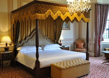 An image of a bedroom with a bed and a chair, Overnight Spa Break. Danesfield House