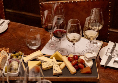 An image of glasses of wine with cheese
