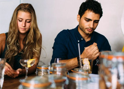 An image of a group of people sitting at a table, The Ginstitute Experience. The Distillery