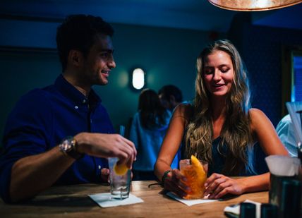 An image of a couple having a drink together, The Ginstitute Experience. The Distillery