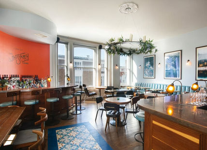 An image of a restaurant with a bar, James Bond Dining Experience. The Distillery