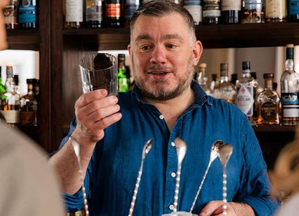 An image of a man drinking a glass of wine, The Whisky Thing Experience. The Distillery