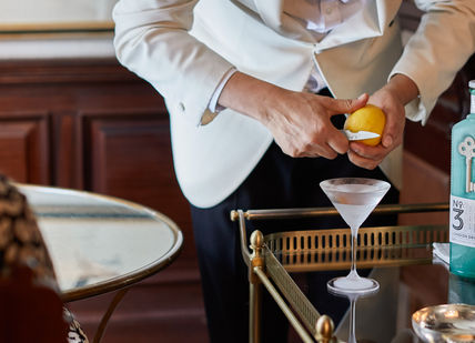 An image of a man in a tuxed suit, Martini Masterclass. The Egerton House Hotel