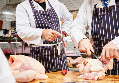 An image of two chefs preparing a chicken, Sausage Making Class. Hampstead Butcher