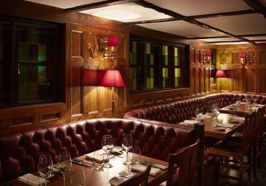An image of a restaurant setting with tables and chairs, Four-Course Menu. The Hind's Head, Bray