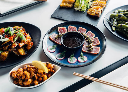 An image of a table with plates of food, Sushi and Sake Masterclass. inamo Restaurants