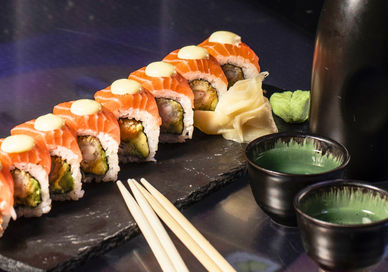 An image of sushi rolls and sake