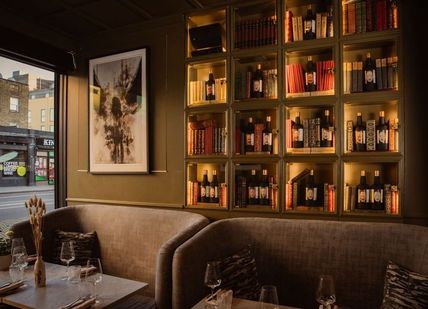 An image of the lounge with displayed sake on the walls