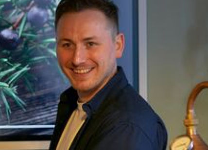An image of a man holding a video game controller, Premium Gin Creation Classs. Liquor Studio