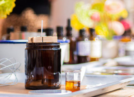 An image of a table with a bunch of flowers, Bespoke Branded Candle Making Class. The London Refinery