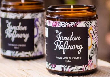 An image of a candle on a table, The Elgin, the Long Room. The London Refinery