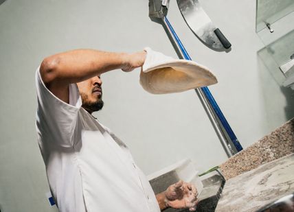 A person making pizza