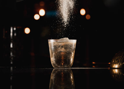 An image of a person pouring water into a glass, Cocktail Making Masterclass with Tapas Style Afternoon Tea. Map Maison