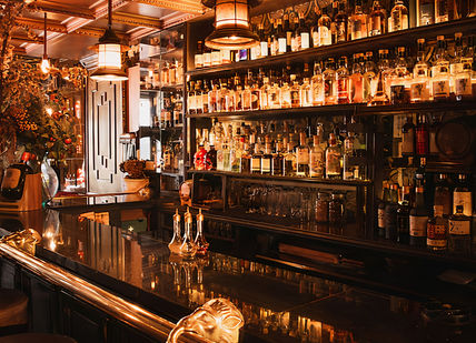 An image of a bar with a lot of bottles, Map Maison. Map Maison