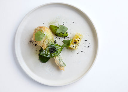 An image of a plate of food on a table, 7-Course Tasting Menu. Marcus