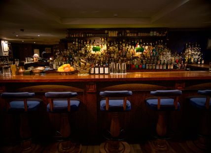 An image of a bar with a bunch of bottles, Premium Gin Tasting Masterclass. Merchant House