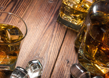 An image of a glass of whiskey and ice, Premium Whisky Masterclass. Merchant House