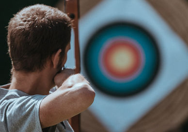 An image of a man holding a baseball bat, Longbow Archery Experience. Now Strike Archery