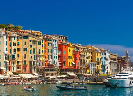 An image of a harbor with boats and buildings, Three-course dinner at Michelin guide listed Restaurant. Osteria Della Corte Restaurant