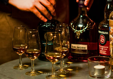An image of glasses and rum bottles