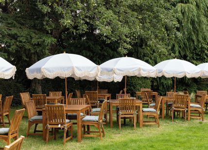 An image of tables and chairs in a garden