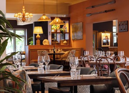 An image of tables and chairs in a restaurant