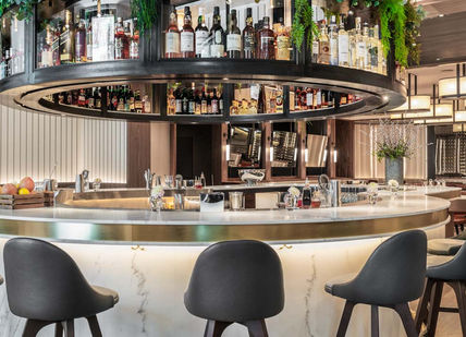An image of a bar with a bar stools, Sette. Sette