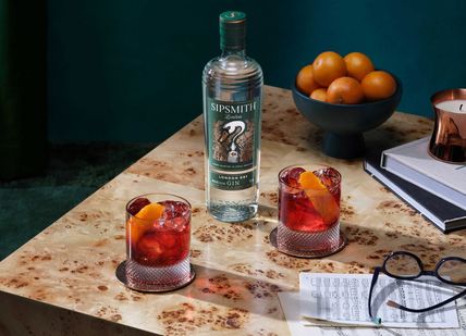 An image of a bottle of gin and glasses of cocktails, Distillery Tour and Gin Tasting. Sipsmith Distillery