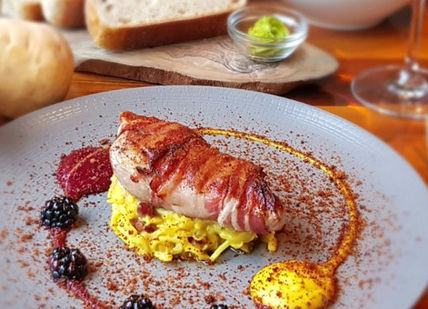 An image of a plate of food on a table, Five-Courses & Drinks. Taisteal
