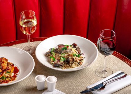 An image of two plates of food and wine, 3 Course Menu. Tuttons