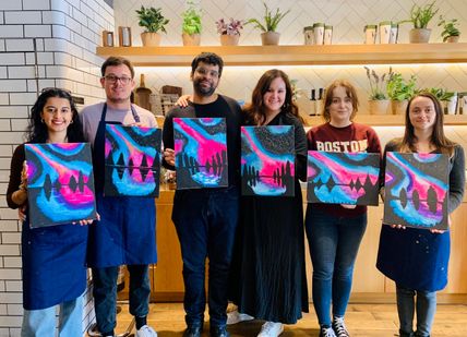 An image of a group of people holding up paintings, Painting Class for Beginners. Undergrounder