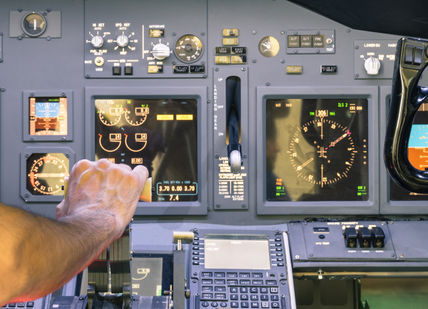 An image of a person in a plane, 60-minute full-motion flight simulation experience. Virtual Aerospace