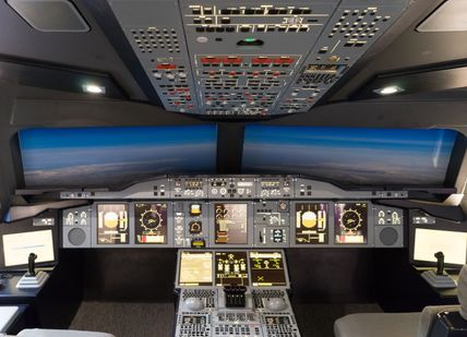 An image of a plane cockpit with a view of the cockpit, 90-minute fixed flight simulation experience. Virtual Aerospace