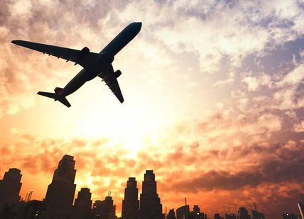 An image of a plane flying over a city, 90-minute fixed flight simulation experience. Virtual Aerospace