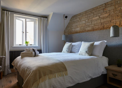 An image of a bedroom with a brick wall, Weekend Overnight Break. Wild Thyme & Honey